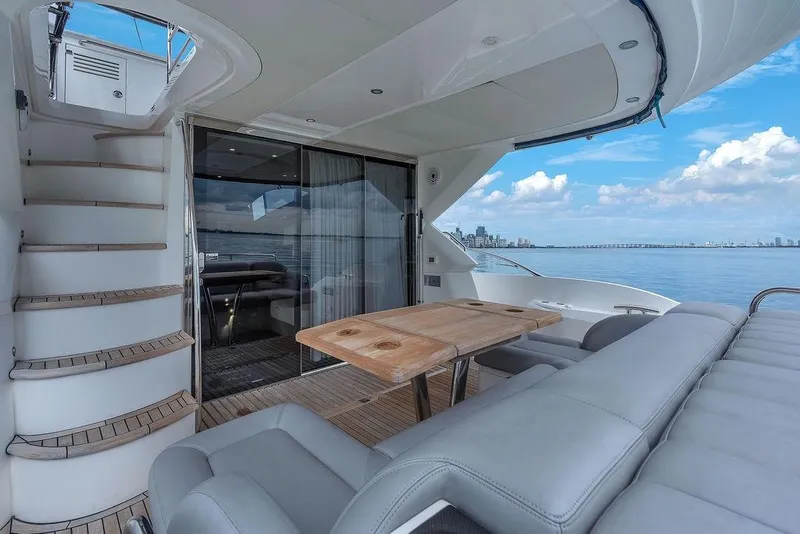 Slide: The Image of Luxurious 2016 Sunseeker Manhattan 55 yacht with elegant outdoor seating and scenic ocean view. - 64