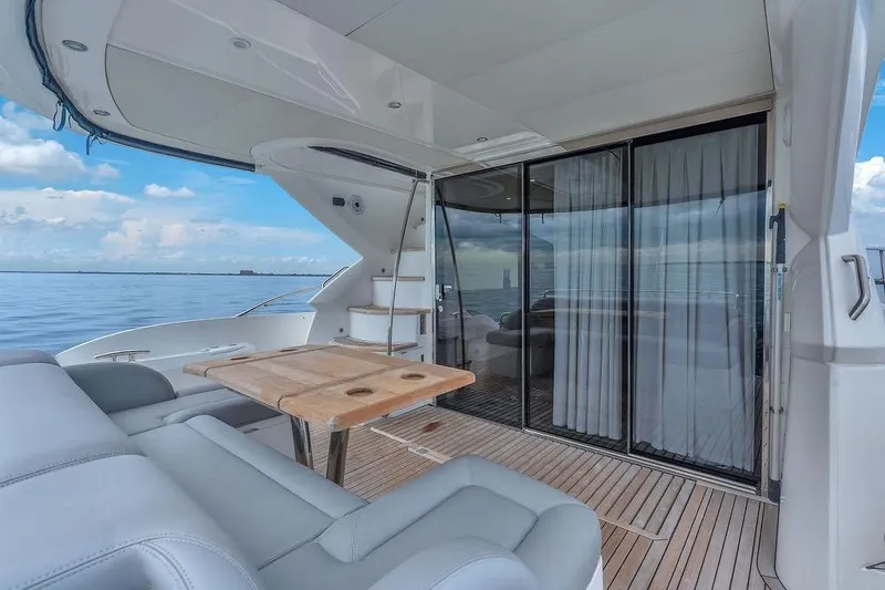 Slide: The Image of Luxurious Sunseeker Manhattan 55 yacht deck with seating, table, and ocean view, 2016 model. - 65