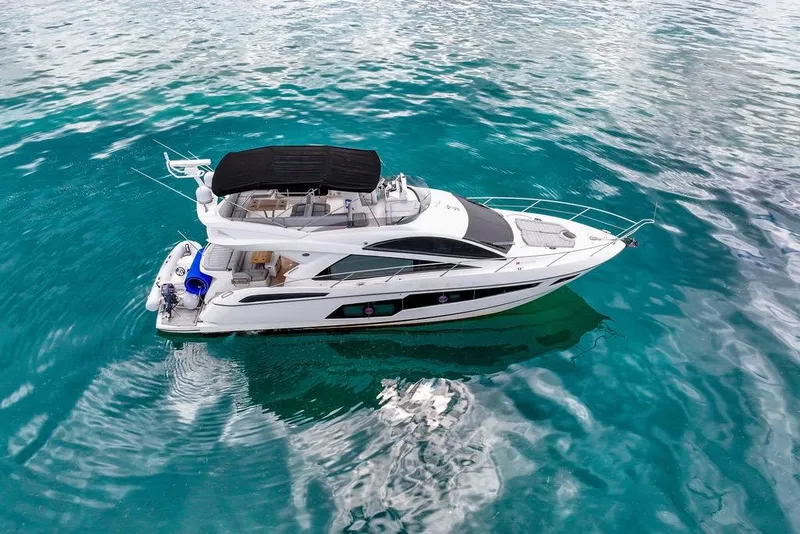 Slide: The Image of 2016 Sunseeker Manhattan 55 yacht on clear turquoise water, aerial view. - 7