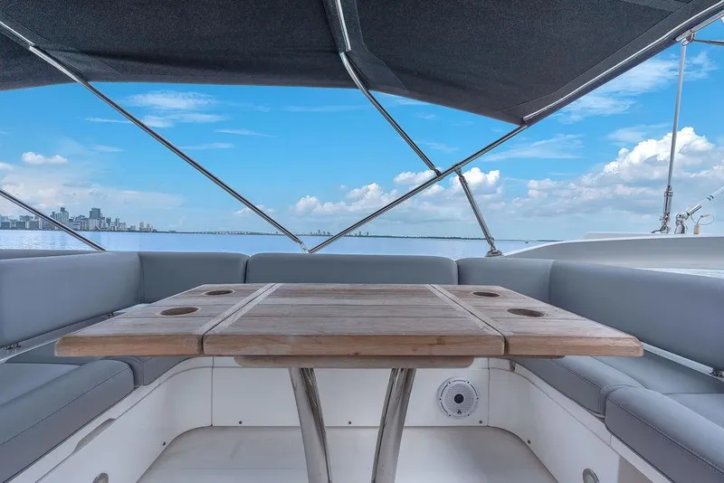 Slide: The Image of Luxurious Sunseeker Manhattan 55 yacht interior with wooden table, ocean view, and city skyline. - 73