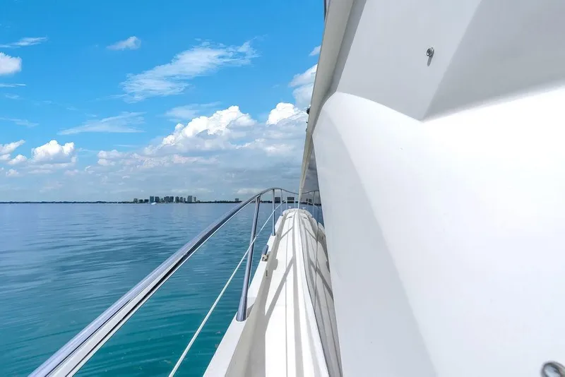 Slide: The Image of 2016 Sunseeker Manhattan 55 yacht cruising on calm blue waters under a clear sky. - 76