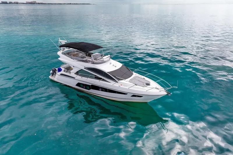 Slide: The Image of 2016 Sunseeker Manhattan 55 yacht on clear turquoise water. - 8