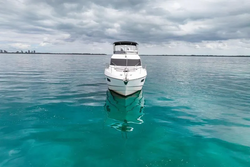 Slide: The Image of 2016 Sunseeker Manhattan 55 yacht on calm turquoise waters under cloudy skies. - 94
