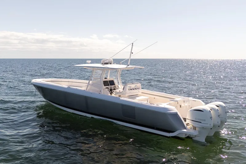 Slide: The Image of 2015 Intrepid 400 Center Console boat on open water, featuring triple Yamaha engines. - 1