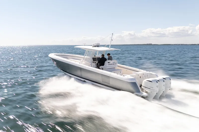 Slide: The Image of 2015 Intrepid 400 Center Console boat cruising on open water, clear sky. - 10