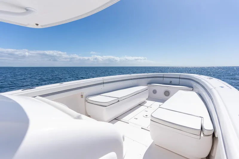 Slide: The Image of 2015 Intrepid 400 Center Console boat with spacious seating, ocean view, and clear blue sky. - 14