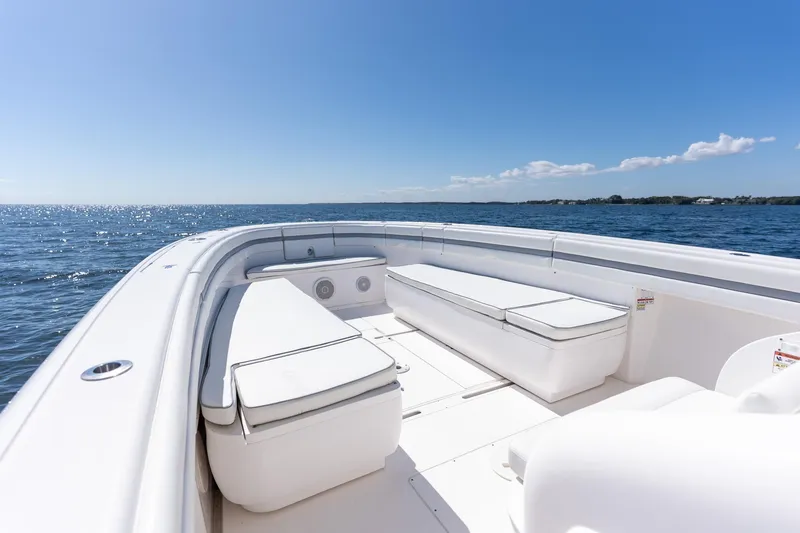 Slide: The Image of 2015 Intrepid 400 Center Console boat on open water, clear sky, spacious seating. - 15