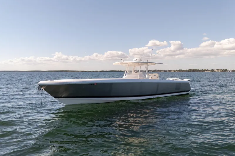 Slide: The Image of 2015 Intrepid 400 Center Console boat on calm water under a clear sky. - 2