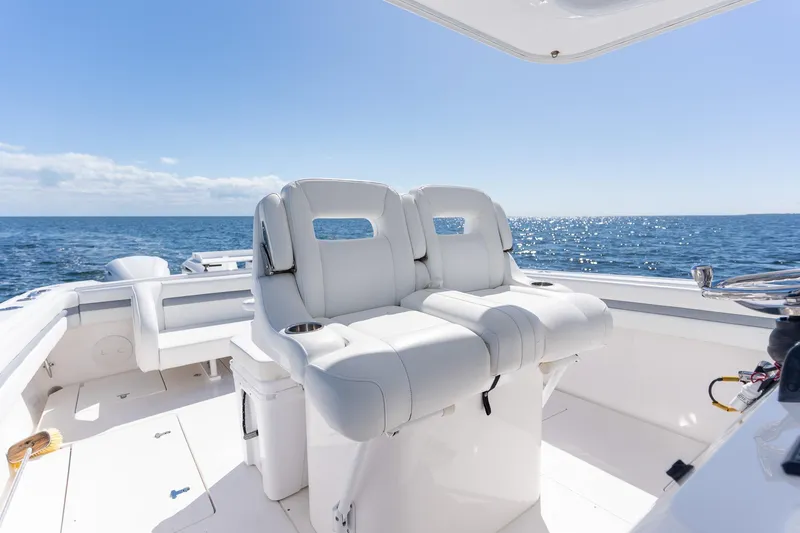 Slide: The Image of 2015 Intrepid 400 Center Console boat interior with ocean view, featuring white seating. - 25