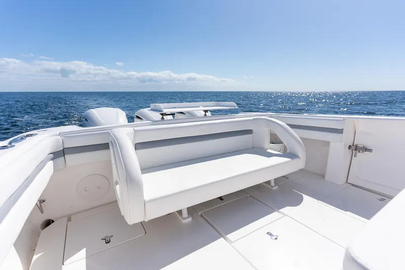 Slide: The Image of 2015 Intrepid 400 Center Console boat with white seating, ocean view, and clear blue sky. - 27
