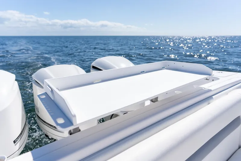 Slide: The Image of 2015 Intrepid 400 Center Console boat with triple outboard engines on open sea. - 28
