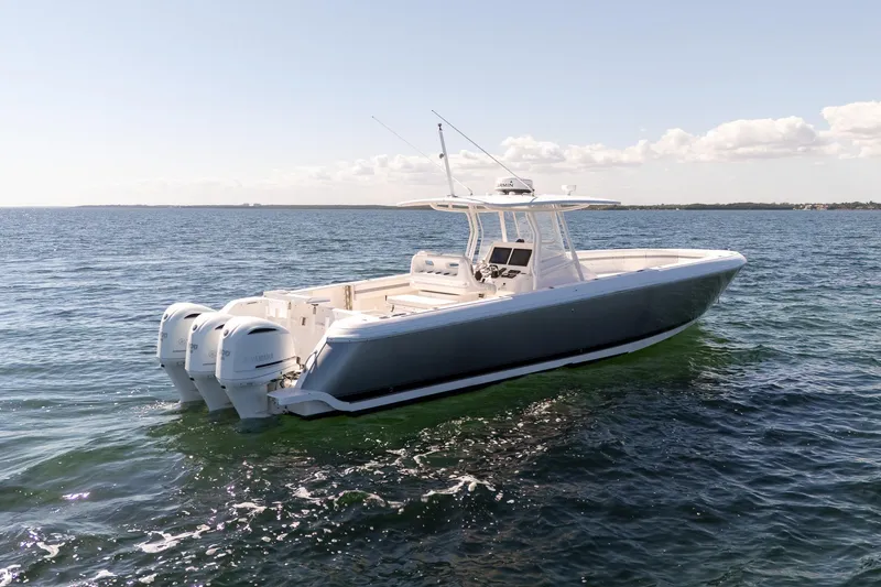 Slide: The Image of 2015 Intrepid 400 Center Console boat on open water, featuring triple outboard engines. - 3