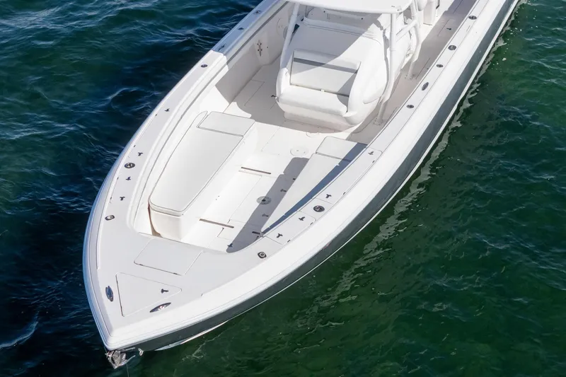 Slide: The Image of 2015 Intrepid 400 Center Console boat on clear water, showcasing sleek design and spacious deck. - 6