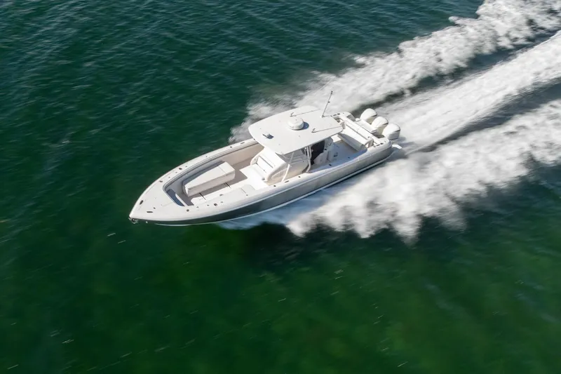 Slide: The Image of 2015 Intrepid 400 Center Console boat speeding on open water. - 8