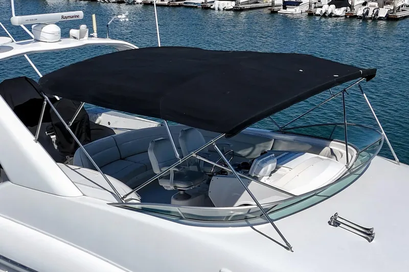 Slide: The Image of 2000 Bayliner 5788 Pilot House Motoryacht with canopy, docked in marina. - 10