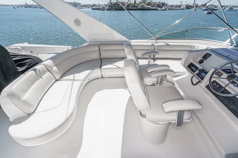 Slide: The Image of Luxurious 2000 Bayliner 5788 Pilot House Motoryacht cockpit with plush seating and steering controls. - 16