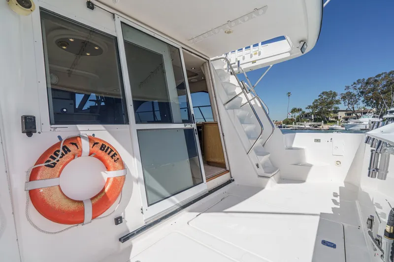 Slide: The Image of 2000 Bayliner 5788 Pilot House Motoryacht deck with life preserver and stairs. - 23