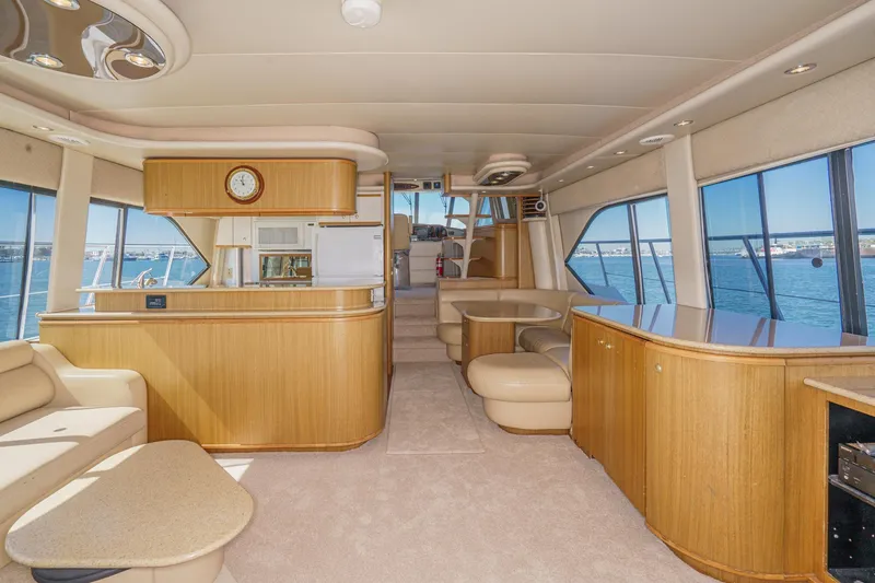 Slide: The Image of Luxurious interior of 2000 Bayliner 5788 Pilot House Motoryacht with panoramic windows and elegant furnishings. - 27