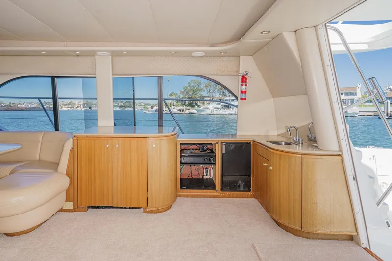 Slide: The Image of Luxurious interior of 2000 Bayliner 5788 Pilot House Motoryacht with waterfront view. - 28
