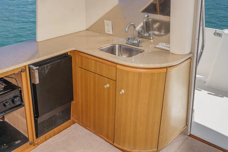 Slide: The Image of Kitchen area of 2000 Bayliner 5788 Pilot House Motoryacht with sink and cabinetry. - 29