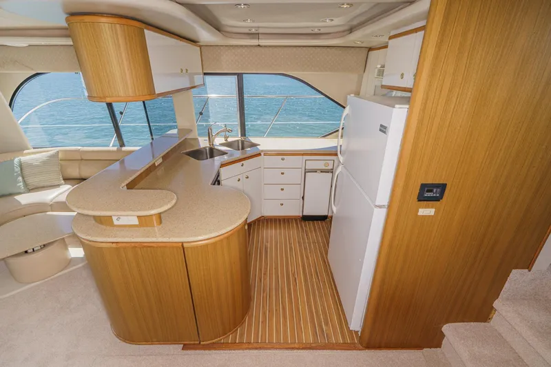 Slide: The Image of Luxurious kitchen interior of 2000 Bayliner 5788 Pilot House Motoryacht with wood accents. - 34