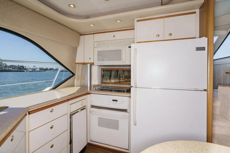 Slide: The Image of Kitchen area of 2000 Bayliner 5788 Pilot House Motoryacht with appliances and waterfront view. - 36