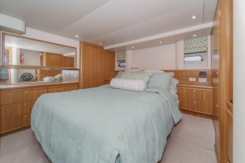 Slide: The Image of Luxurious bedroom interior of 2000 Bayliner 5788 Pilot House Motoryacht with elegant wood cabinetry. - 42