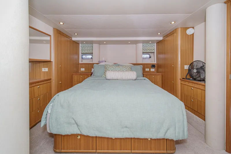 Slide: The Image of Luxurious bedroom interior of 2000 Bayliner 5788 Pilot House Motoryacht with elegant wood cabinetry. - 43