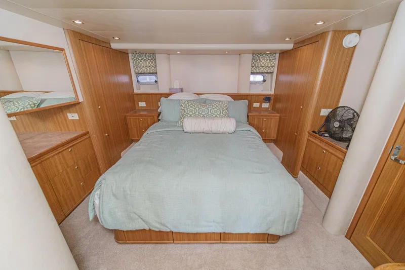 Slide: The Image of Luxurious bedroom interior of 2000 Bayliner 5788 Pilot House Motoryacht with elegant wood finish. - 44