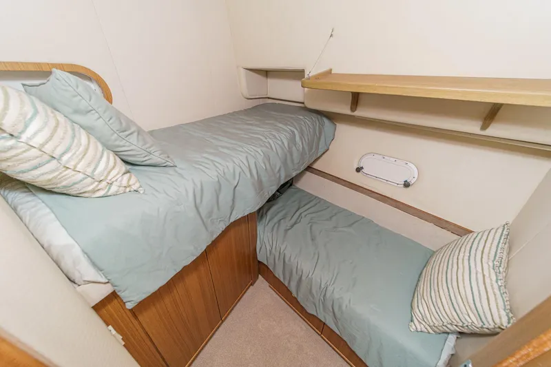 Slide: The Image of Cozy twin cabin in 2000 Bayliner 5788 Pilot House Motoryacht with striped pillows. - 53