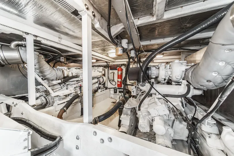Slide: The Image of Engine room of 2000 Bayliner 5788 Pilot House Motoryacht, showcasing mechanical components. - 54