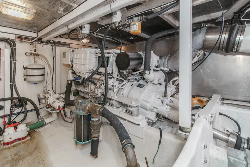 Slide: The Image of Engine room of 2000 Bayliner 5788 Pilot House Motoryacht, showcasing mechanical components. - 58
