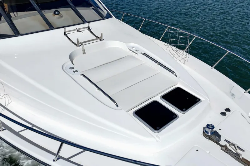 Slide: The Image of 2000 Bayliner 5788 Pilot House Motoryacht deck with sunbathing area and ocean view. - 7