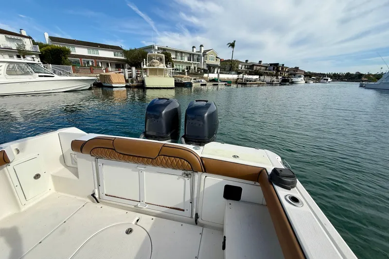 Slide: The Image of 2008 Everglades 290 Center Console boat docked in a scenic marina setting. - 13