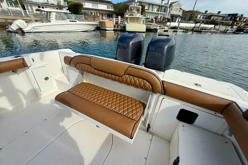 Slide: The Image of 2008 Everglades 290 Center Console boat with tan seating, dual engines, docked in marina. - 14