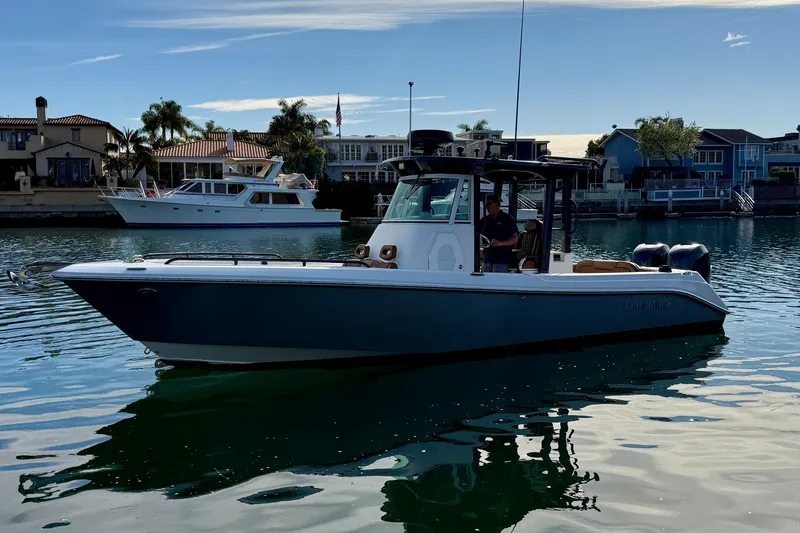 Slide: The Image of 2008 Everglades 290 Center Console boat on calm water near waterfront homes. - 4
