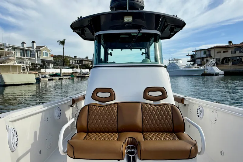 Slide: The Image of 2008 Everglades 290 Center Console boat with brown seating, docked in a marina. - 6