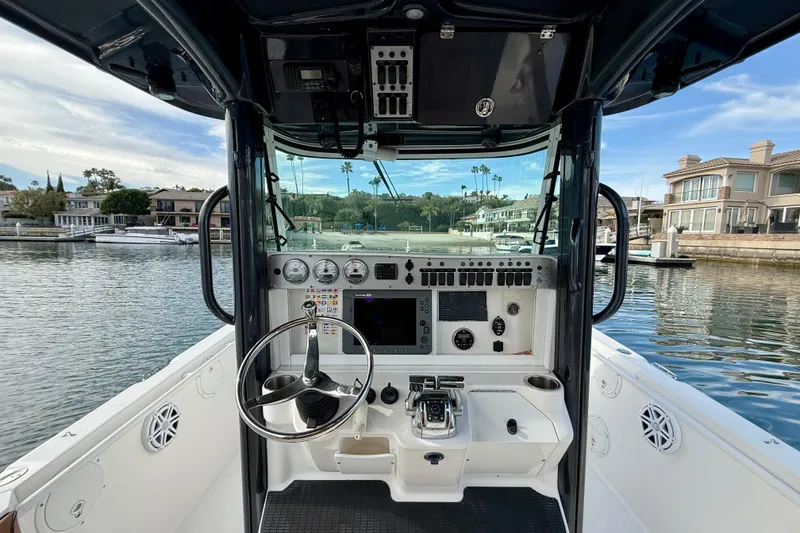 Slide: The Image of 2008 Everglades 290 Center Console boat interior with steering wheel and control panel. - 7
