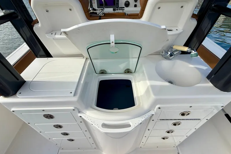 Slide: The Image of 2008 Everglades 290 Center Console boat interior with sink and storage compartments. - 8