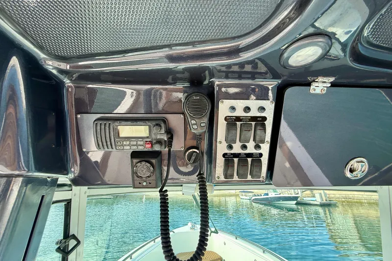 Slide: The Image of Control panel of 2008 Everglades 290 Center Console boat with radio and switches. - 9