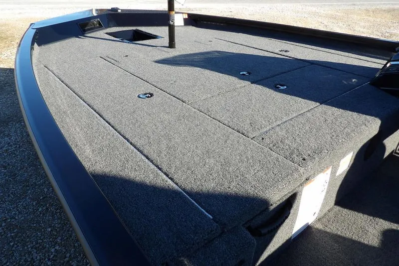 Slide: The Image of 2026 Crestliner XFC 189 boat deck with carpeted surface and storage compartments. - 10