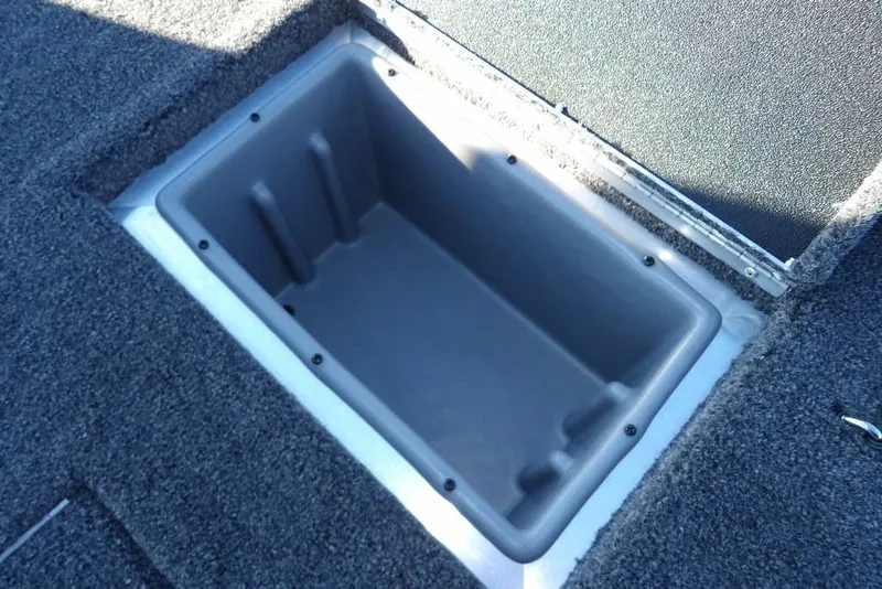Slide: The Image of 2026 Crestliner XFC 189 boat storage compartment with open lid, showcasing interior space. - 13