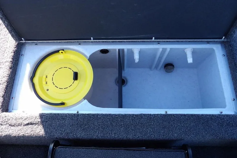 Slide: The Image of 2026 Crestliner XFC 189 livewell with yellow lid and plumbing fixtures. - 14