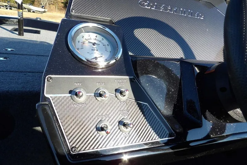 Slide: The Image of Dashboard of 2026 Crestliner XFC 189 boat with RPM gauge and control switches. - 22