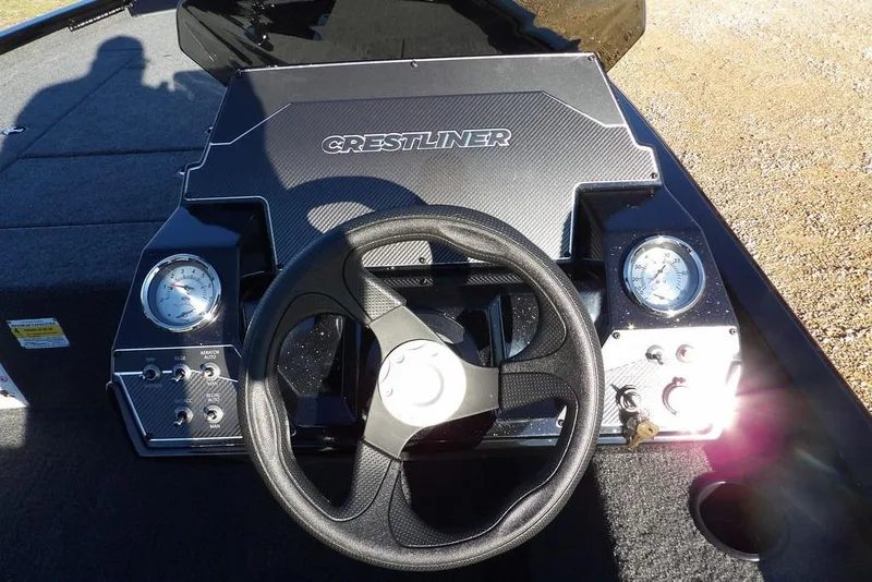 Slide: The Image of 2026 Crestliner XFC 189 boat dashboard with steering wheel and gauges. - 24