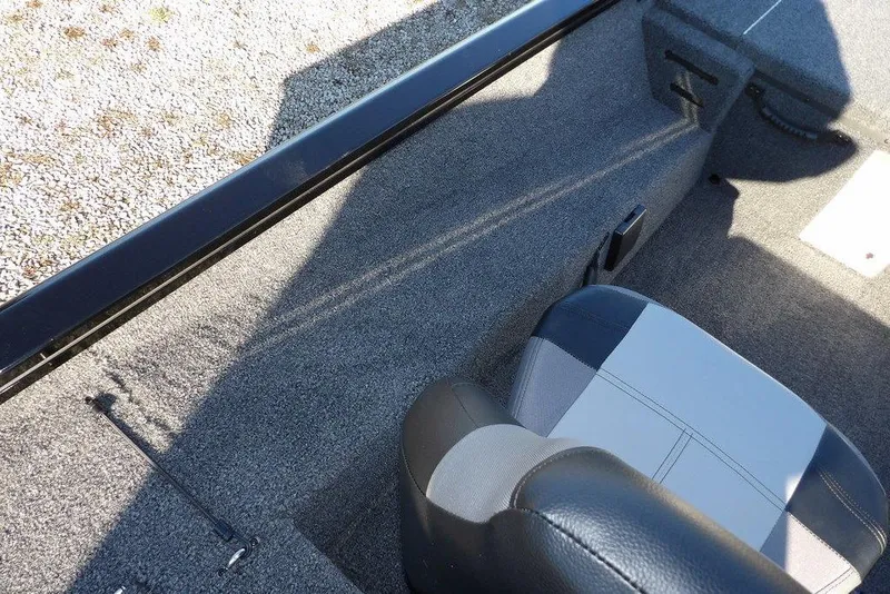 Slide: The Image of Interior view of 2026 Crestliner XFC 189 boat, featuring gray carpet and seating. - 25