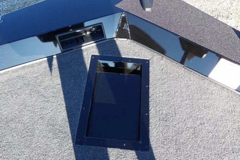 Slide: The Image of 2026 Crestliner XFC 189 boat deck with storage compartment and sleek black finish. - 29