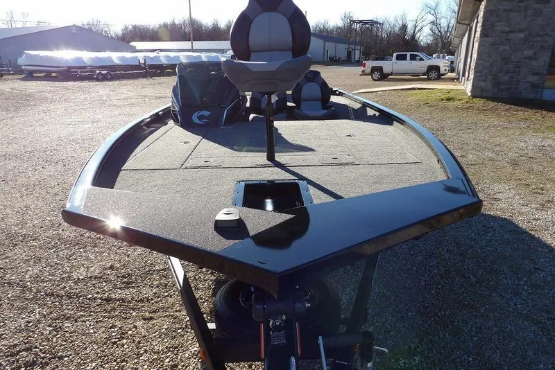 Slide: The Image of 2026 Crestliner XFC 189 fishing boat with spacious deck and seating, parked outdoors. - 3