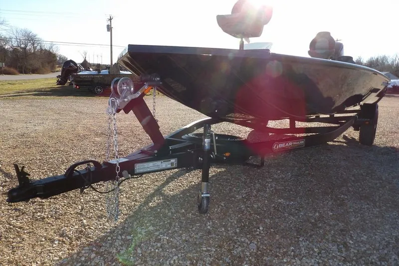Slide: The Image of 2026 Crestliner XFC 189 boat on trailer, parked on gravel under bright sunlight. - 34