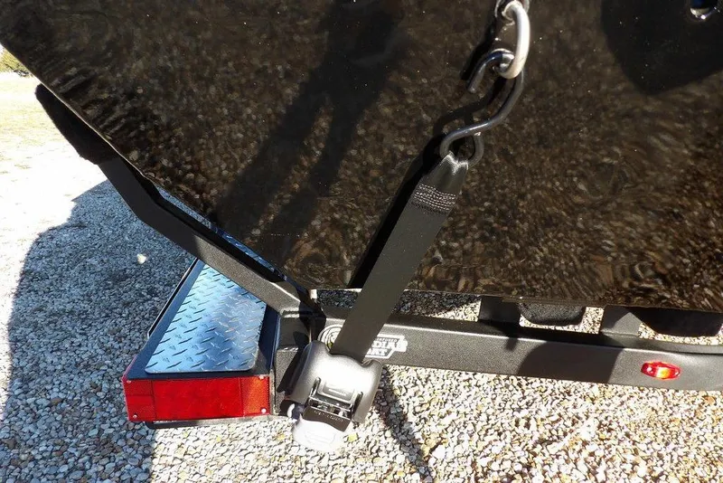 Slide: The Image of 2026 Crestliner XFC 189 boat trailer with secure tie-down strap and red reflector. - 39